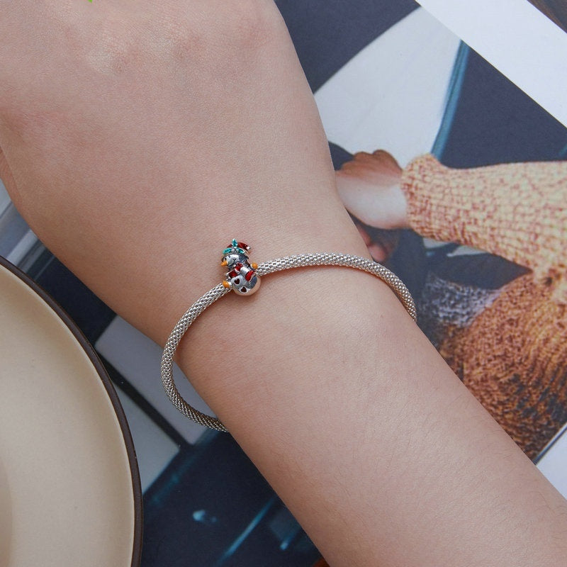 Snowman Charm - Festive Winter Collection | Christmas Jewelry featured on a silver bracelet worn on wrist. Adds holiday cheer to any charm bracelet.