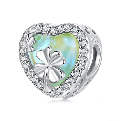 Silver heart-shaped charm with clover design and '925' stamp on a white background