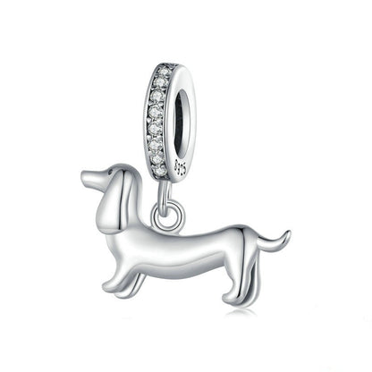 Silver dachshund charm with clear stones on a white background, featuring 'Real Sterling Silver' stamp.