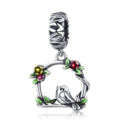 Bird charm with colorful floral accents